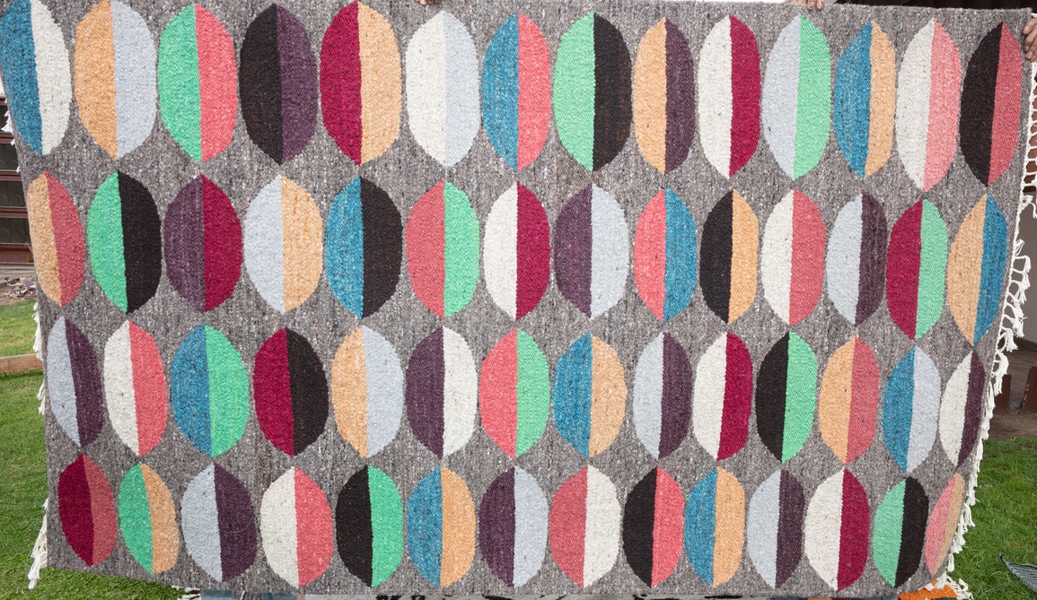 Hand-woven Karakul wool carpet with traditional Namibian design